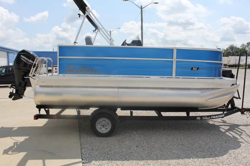 Slide: The Image of 2026 Sun Tracker Party Barge 16 DLX pontoon boat on trailer, side view. - 3