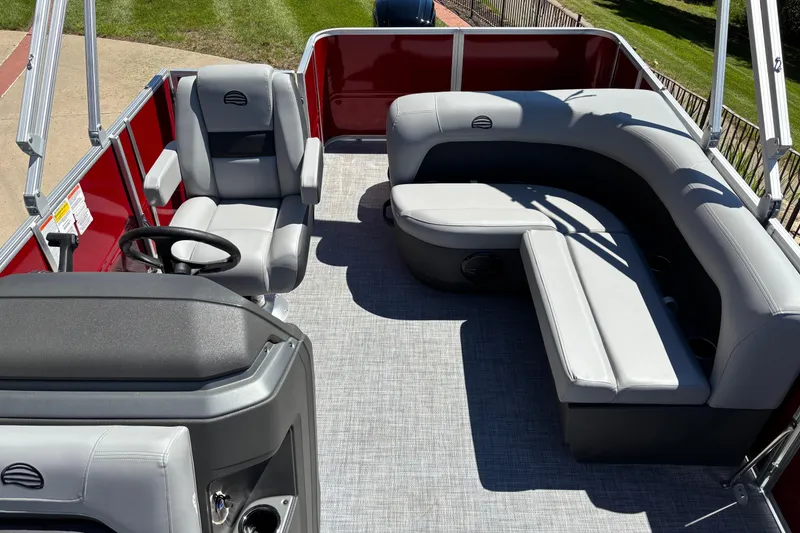 Slide: The Image of 2026 Sun Tracker Party Barge 18 DLX interior with gray seating and red exterior. - 3