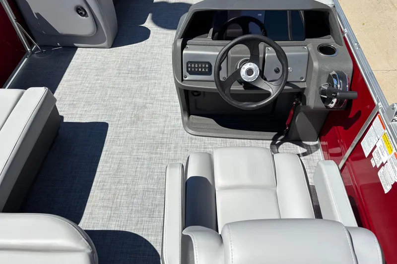 Slide: The Image of 2026 Sun Tracker Party Barge 18 DLX interior with steering wheel and seating. - 4