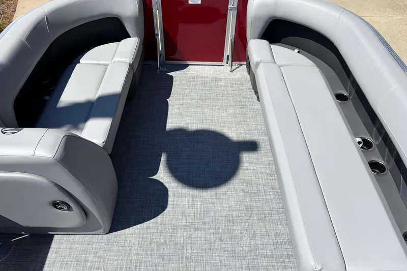 Slide: The Image of 2026 Sun Tracker Party Barge 18 DLX interior with gray seating and flooring. - 5