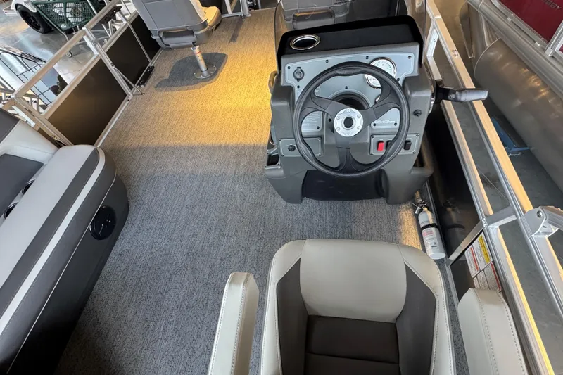 Slide: The Image of 2026 Sun Tracker Bass Buggy 18 DLX interior with steering console and seating. - 14