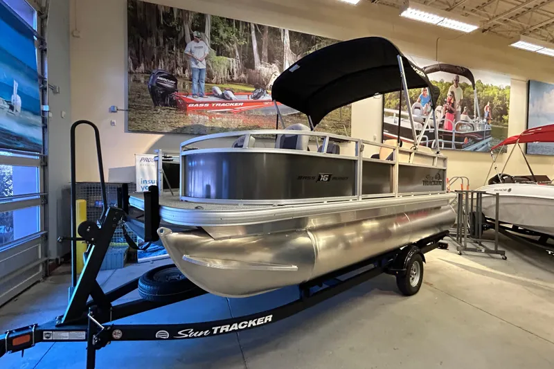 The Image of 2026 Sun Tracker Bass Buggy 16 XL Select pontoon boat displayed indoors. - 0
