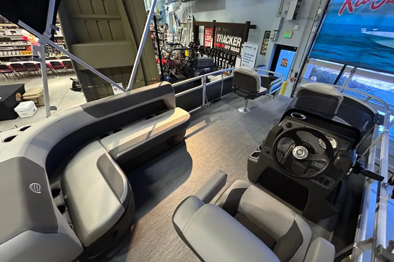 Slide: The Image of Interior of 2026 Sun Tracker Bass Buggy 16 XL Select pontoon boat with seating and steering console. - 3