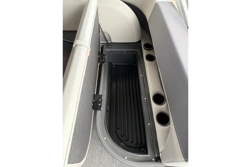 Slide: The Image of 2026 Sun Tracker Bass Buggy 16 XL Select storage compartment with cup holders. - 13