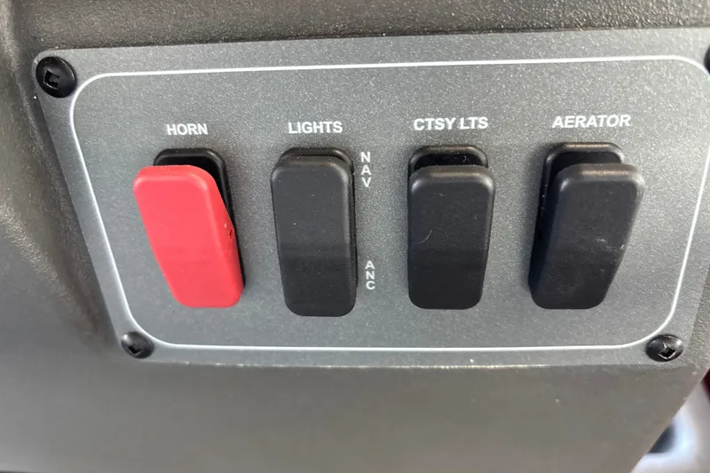 Slide: The Image of Control panel of 2026 Sun Tracker Bass Buggy 16 XL Select with switches for horn, lights, and aerator. - 17