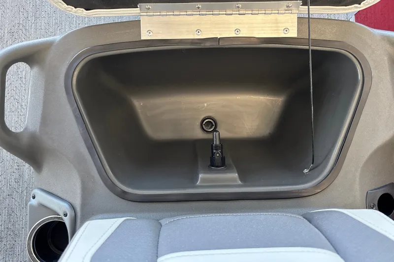 Slide: The Image of 2026 Sun Tracker Bass Buggy 16 XL Select storage compartment with cup holder and seat detail. - 20