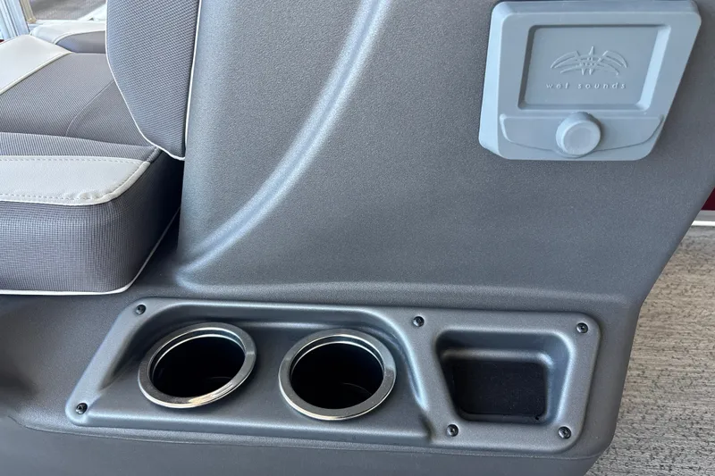 Slide: The Image of Interior of 2026 Sun Tracker Bass Buggy 16 XL Select with cup holders and audio controls. - 19
