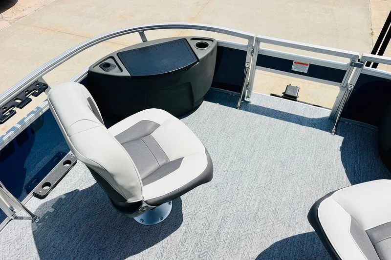 Slide: The Image of 2026 Sun Tracker Bass Buggy 18 DLX pontoon boat interior with seating and console. - 13