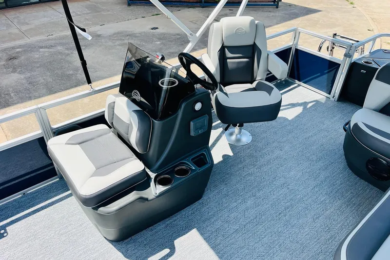 Slide: The Image of 2026 Sun Tracker Bass Buggy 18 DLX interior with steering console and seating. - 18