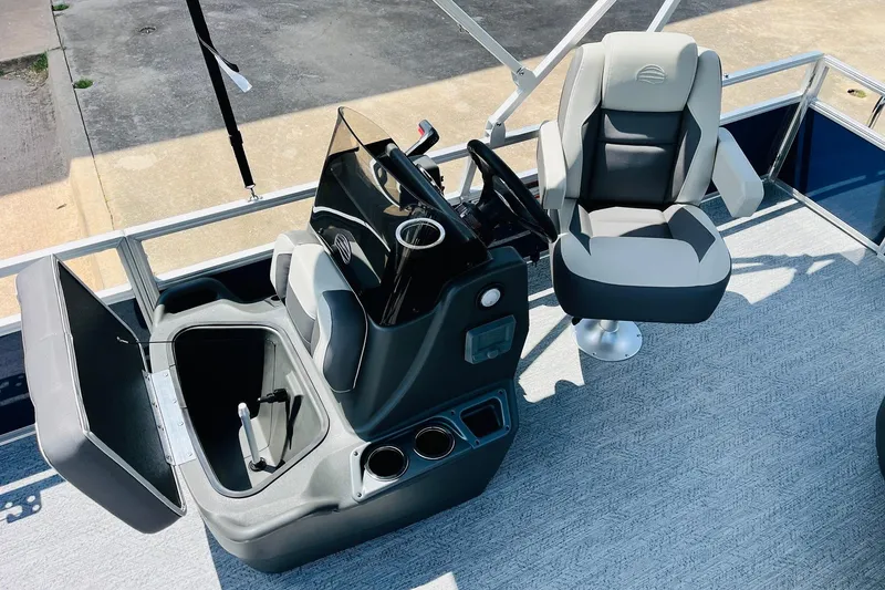 Slide: The Image of 2026 Sun Tracker Bass Buggy 18 DLX interior with captain's chair and console. - 19
