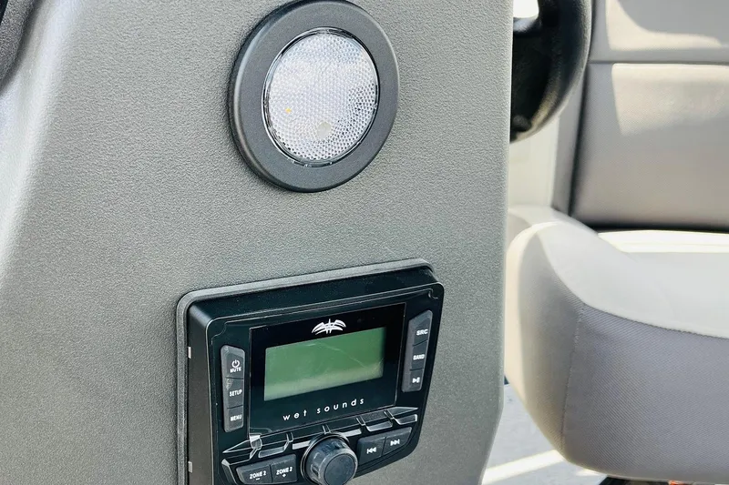 Slide: The Image of 2026 Sun Tracker Bass Buggy 18 DLX dashboard with Wet Sounds audio system. - 22