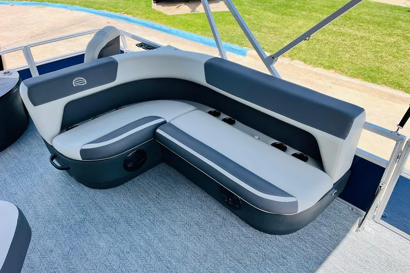 Slide: The Image of 2026 Sun Tracker Bass Buggy 18 DLX pontoon boat interior with cushioned seating. - 24