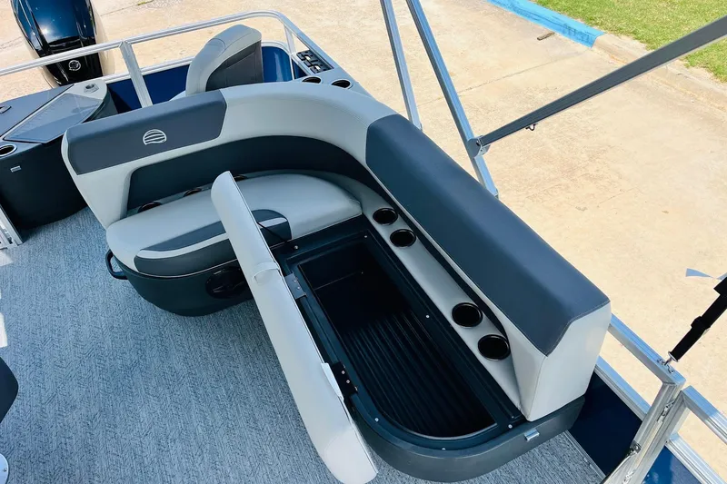 Slide: The Image of 2026 Sun Tracker Bass Buggy 18 DLX pontoon boat with open storage compartment and cup holders. - 27