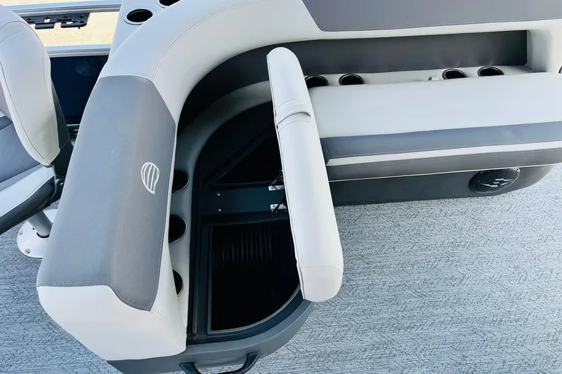 Slide: The Image of 2026 Sun Tracker Bass Buggy 18 DLX boat interior with storage compartment and cup holders. - 28