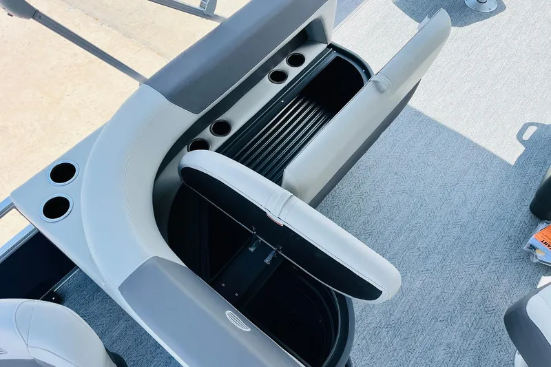 Slide: The Image of 2026 Sun Tracker Bass Buggy 18 DLX interior seating with storage and cup holders. - 29