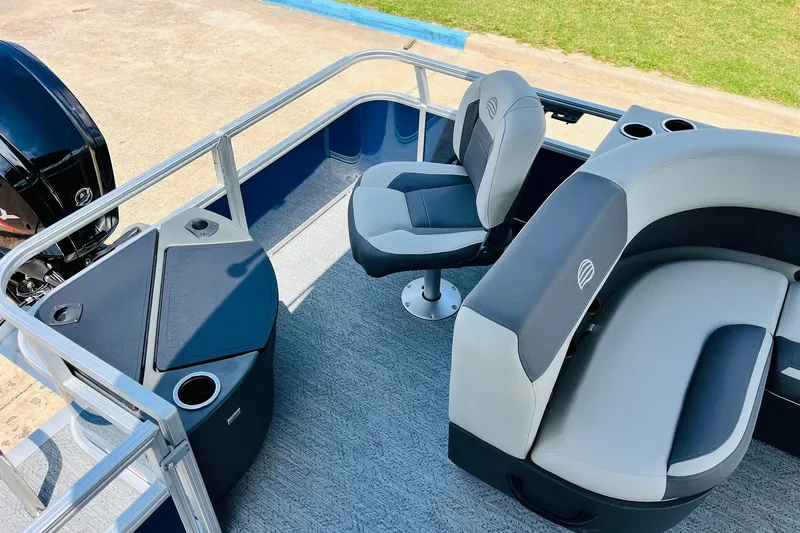 Slide: The Image of 2026 Sun Tracker Bass Buggy 18 DLX pontoon boat interior with seating and motor. - 30