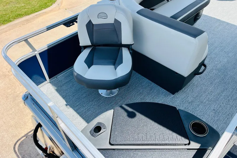Slide: The Image of 2026 Sun Tracker Bass Buggy 18 DLX interior with seating and cup holder. - 31