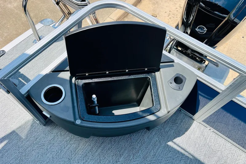 Slide: The Image of 2026 Sun Tracker Bass Buggy 18 DLX boat with open storage compartment and cup holder. - 33
