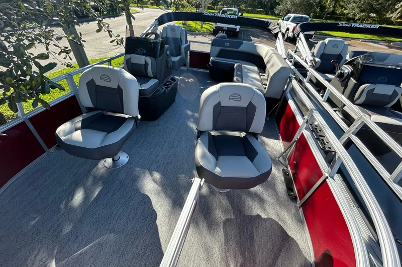 Slide: The Image of 2026 Sun Tracker Bass Buggy 16 XL Select pontoon boat interior with seating and steering console. - 2