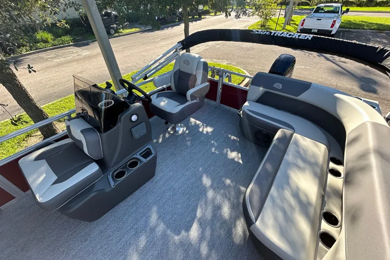 Slide: The Image of 2026 Sun Tracker Bass Buggy 16 XL Select pontoon boat interior with seating and steering console. - 3