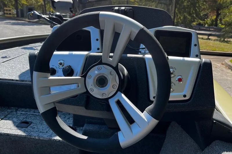Slide: The Image of Steering wheel of 2026 Tracker Pro Team 195 boat, featuring modern dashboard controls. - 7