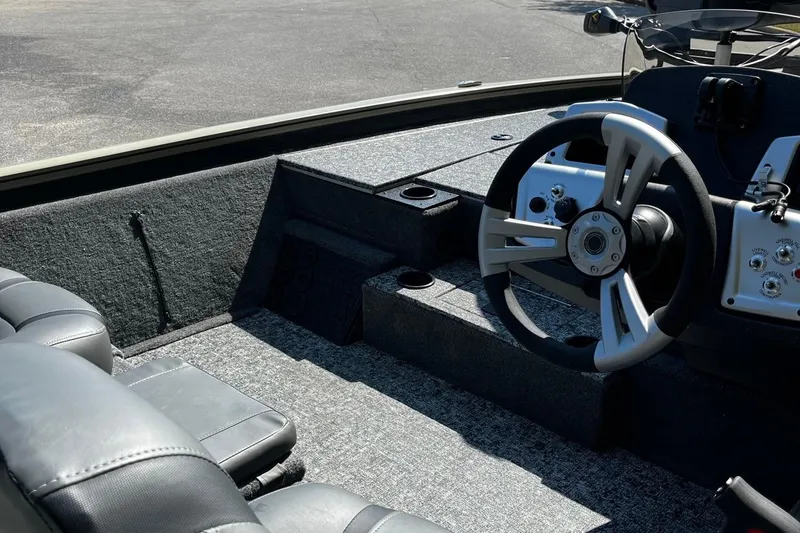 Slide: The Image of 2026 Tracker Pro Team 195 boat interior with steering wheel and seating. - 9