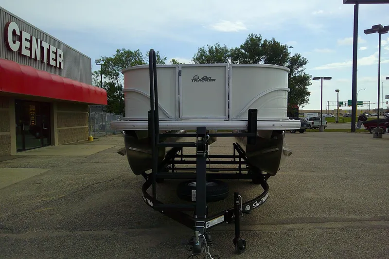 Slide: The Image of 2026 Sun Tracker Party Barge 16 DLX on trailer outside dealership. - 49
