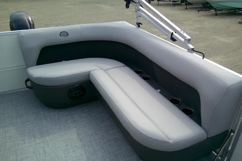 Slide: The Image of 2026 Sun Tracker Party Barge 16 DLX interior seating with cup holders, gray upholstery. - 54