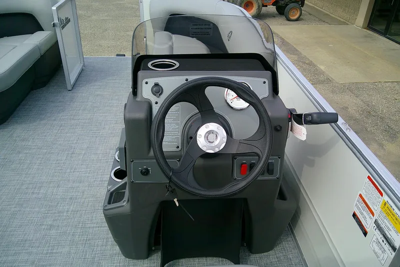 Slide: The Image of 2026 Sun Tracker Party Barge 16 DLX steering console with modern controls and seating. - 55