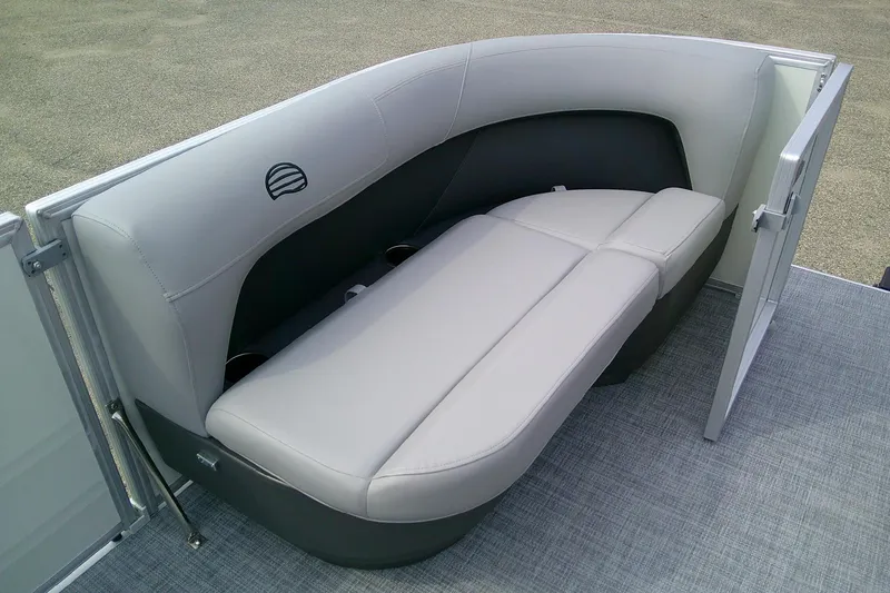 Slide: The Image of 2026 Sun Tracker Party Barge 16 DLX interior seating with gray upholstery and open side gate. - 6