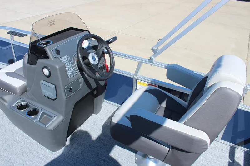 Slide: The Image of 2026 Sun Tracker Bass Buggy 16 XL Select boat interior with steering console and seating. - 12