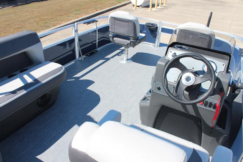 Slide: The Image of 2026 Sun Tracker Bass Buggy 16 XL Select pontoon boat interior with steering console and seating. - 14