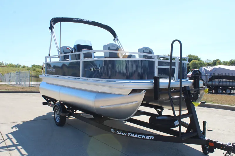 Slide: The Image of 2026 Sun Tracker Bass Buggy 16 XL Select pontoon boat at dealership. - 3