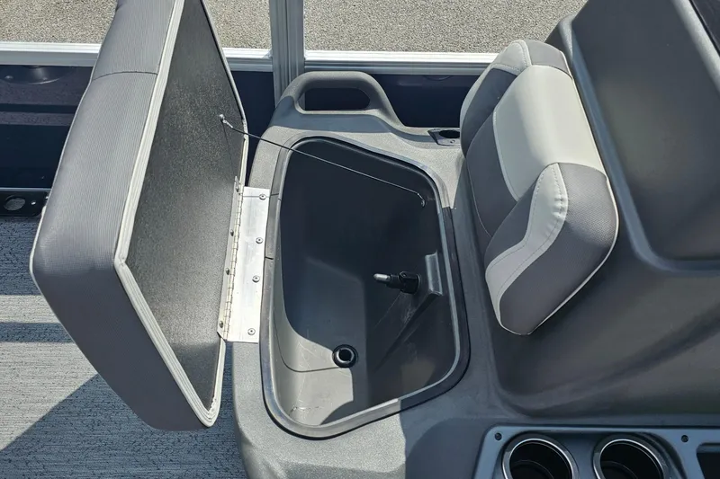 Slide: The Image of 2026 Sun Tracker Bass Buggy 18 DLX seat storage compartment open, showcasing interior space. - 13