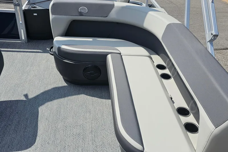 Slide: The Image of 2026 Sun Tracker Bass Buggy 18 DLX boat interior with cushioned seating and cup holders. - 14
