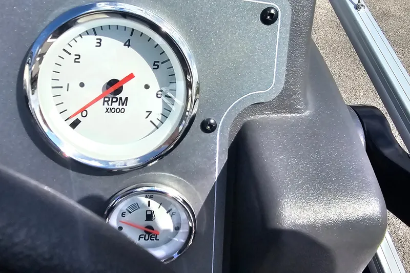 Slide: The Image of 2026 Sun Tracker Bass Buggy 18 DLX dashboard with RPM and fuel gauges. - 18