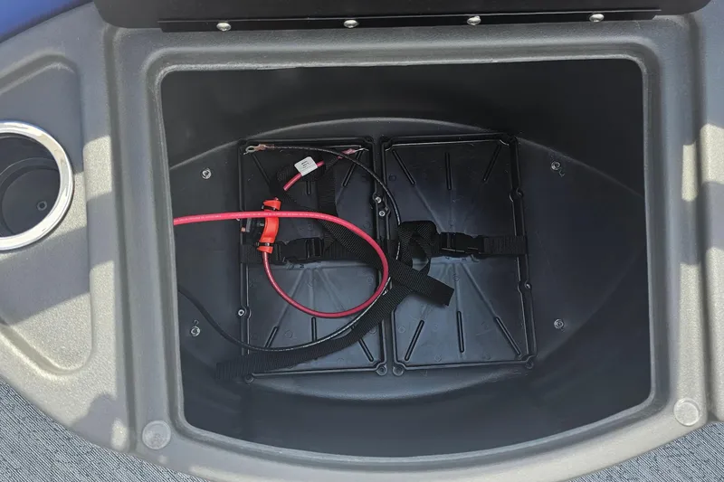 Slide: The Image of Battery compartment of 2026 Sun Tracker Fishin' Barge 20 DLX with wiring and straps. - 11