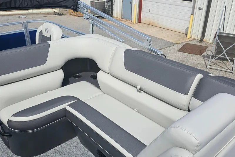 Slide: The Image of 2026 Sun Tracker Fishin' Barge 20 DLX interior with gray and white seating. - 13