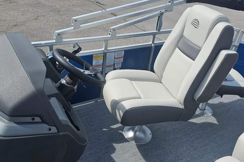 Slide: The Image of 2026 Sun Tracker Fishin' Barge 20 DLX helm with comfortable captain's chair and steering wheel. - 14