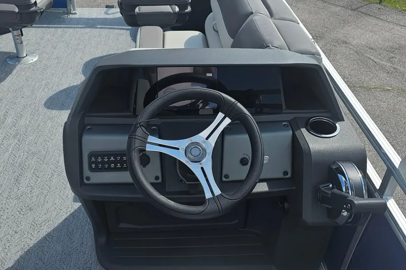 Slide: The Image of 2026 Sun Tracker Fishin' Barge 20 DLX steering console with modern controls and seating. - 15