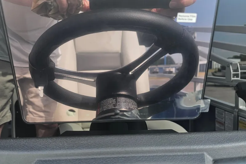 Slide: The Image of 2026 Sun Tracker Fishin' Barge 20 DLX steering wheel close-up. - 17