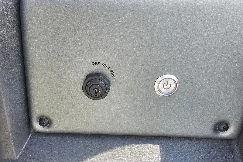 Slide: The Image of Control panel of 2026 Sun Tracker Fishin' Barge 20 DLX with ignition and power button. - 18