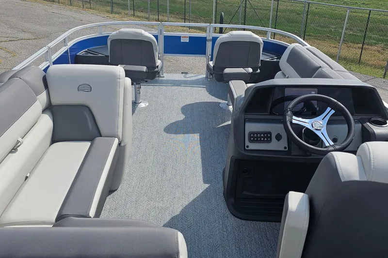 Slide: The Image of 2026 Sun Tracker Fishin' Barge 20 DLX interior with seating and steering console. - 23