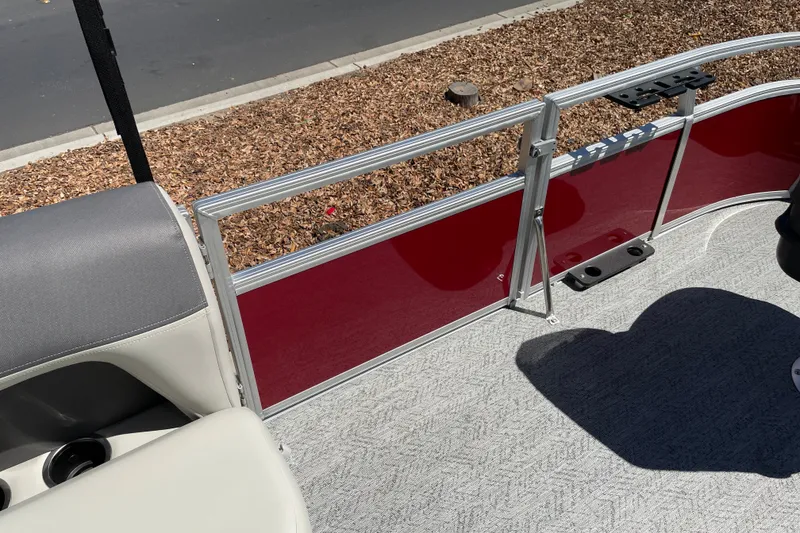 Slide: The Image of 2026 Sun Tracker Bass Buggy 16 XL Select pontoon interior with red paneling and gray seating. - 24