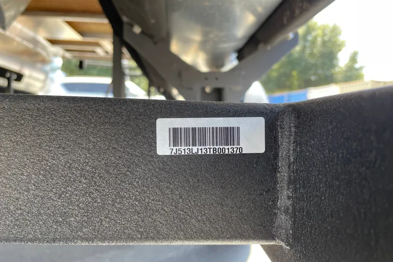 Slide: The Image of 2026 Sun Tracker Bass Buggy 16 XL Select trailer with visible barcode and serial number. - 99