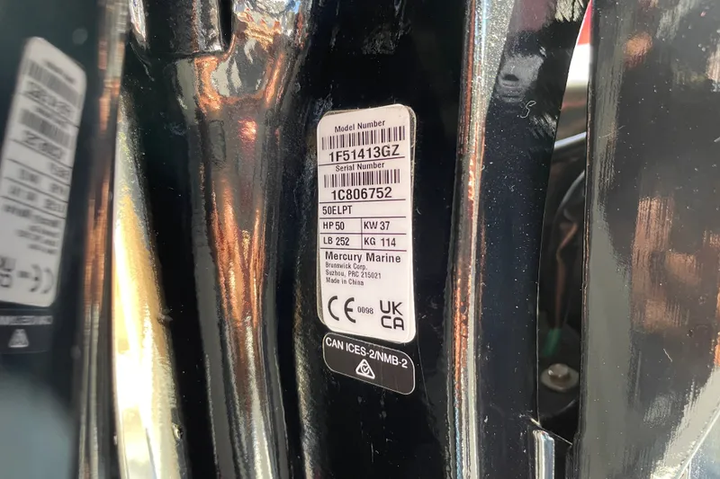 Slide: The Image of Close-up of a 2026 Sun Tracker Bass Buggy 16 XL Select engine label. - 98