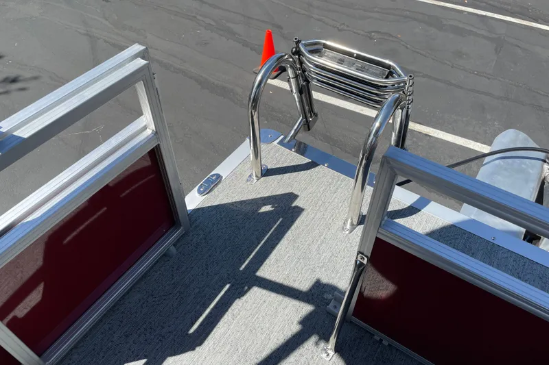 Slide: The Image of 2026 Sun Tracker Bass Buggy 16 XL Select pontoon boat deck with ladder and railing. - 23