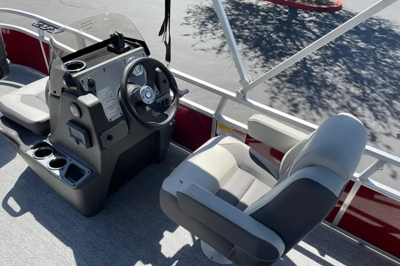 Slide: The Image of 2026 Sun Tracker Bass Buggy 16 XL Select boat interior with steering console and seating. - 14