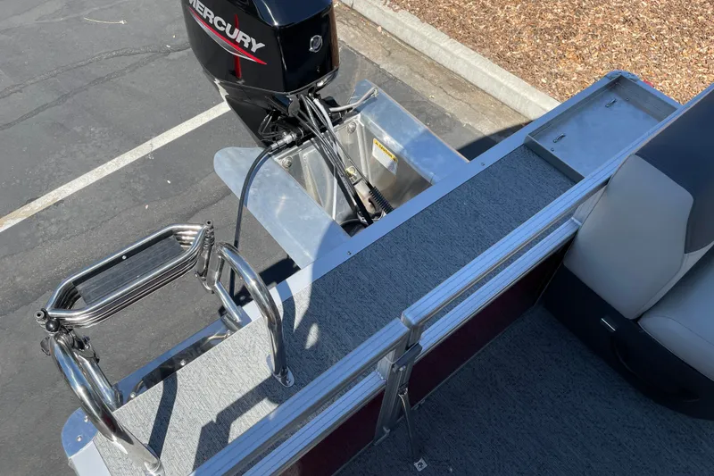 Slide: The Image of 2026 Sun Tracker Bass Buggy 16 XL Select with Mercury outboard motor and boarding ladder. - 15