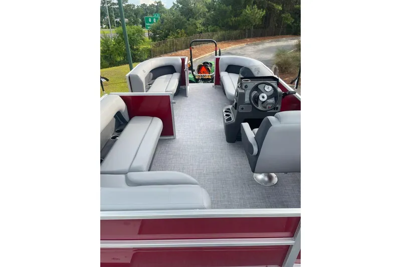 Slide: The Image of 2026 Sun Tracker Party Barge 16 DLX interior with spacious seating and modern helm. - 2